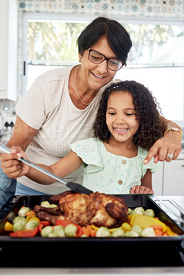 Buy stock photo Kitchen, health and a grandmother cooking with her grandchild in their home together for thanksgiving. Children, love and a roast with a senior woman preparing a meal with a girl for food nutrition