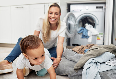 Buy stock photo Child, mother and laundry at home with family for housework, chores and clean clothes. A happy woman with a washing machine for cleaning and playing with toddler kid while multitasking as a mom