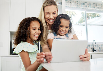 Buy stock photo Blended family, adoption and a mother with her children on a tablet in the kitchen for education or learning. Children, diversity and study with woman teaching her girl kids in their home together