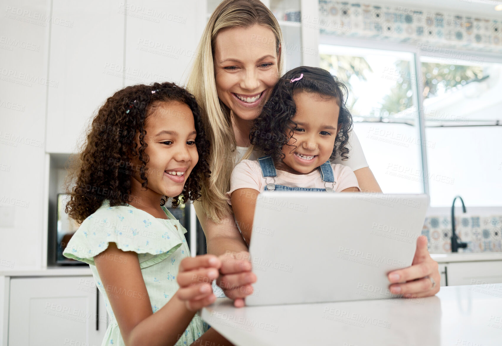 Buy stock photo Blended family, adoption and a mother with her children on a tablet in the kitchen for education or learning. Children, diversity and study with woman teaching her girl kids in their home together