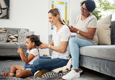 Buy stock photo Living room, mother and daughter to braid hair, generations and bonding with love, care or sitting on carpet. Mom, grandmother and child with hairdresser, tablet or play games on floor in family home