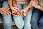 Support, holding hands and family bonding together on the sofa in the living room of their home. Unity, connection and closeup of people in unity with affection moment for empathy in their house.