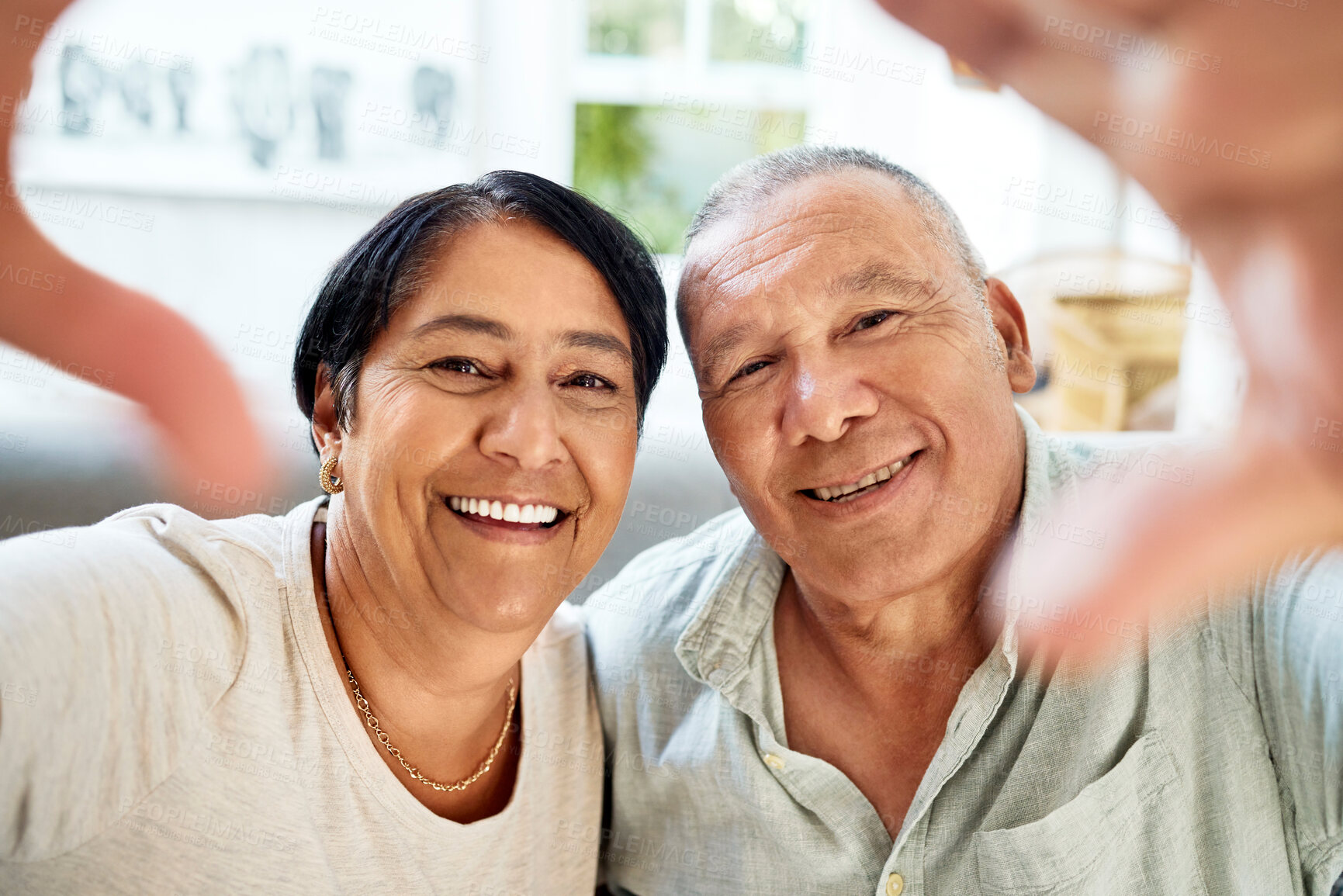 Buy stock photo Mature couple, selfie and smile portrait on home sofa for video call, streaming and internet. A happy man and woman together on a couch for social media profile picture or memory of healthy marriage