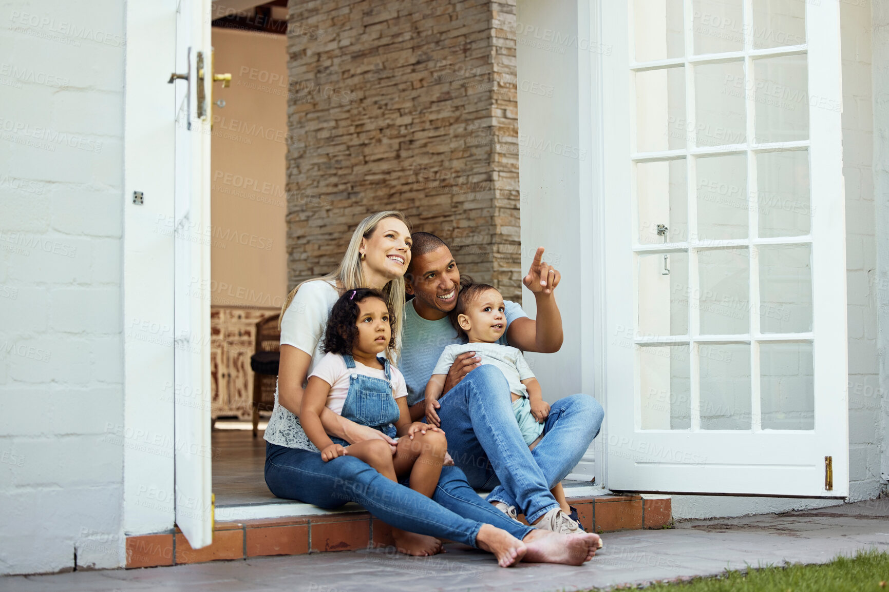 Buy stock photo Parents, children and sitting on steps, outdoor and pointing with view, thinking and relax in backyard at family home. Interracial couple, young kids and happy together on patio, veranda and garden