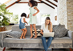 Mother, headache and work from home on laptop, kids or jump on sofa in living room, comic game or fun. Mom, girl siblings and computer with stress, burnout or tired with freelance job in family house