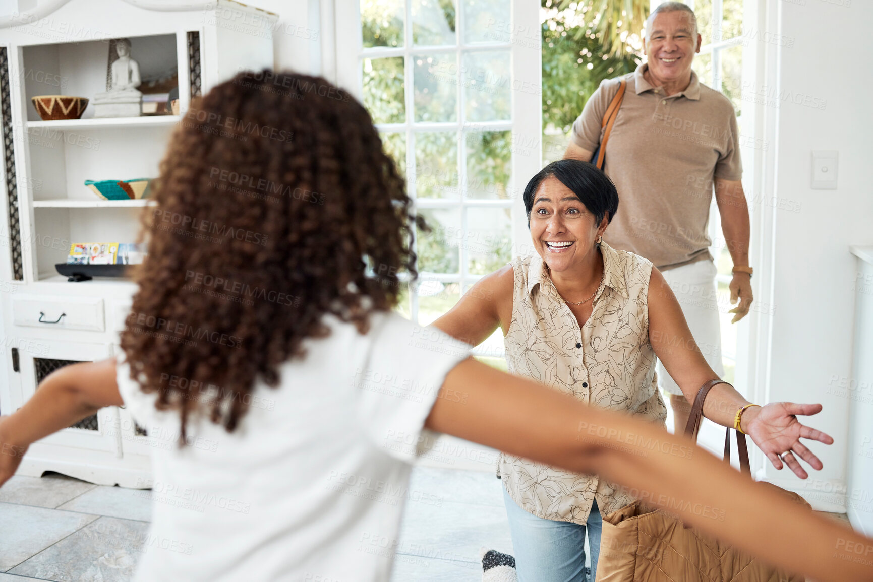 Buy stock photo Hello, home and girl running to grandparents by door excited for bonding, spending time and relationship. Family, happy and grandmother, grandfather and child embrace for greeting, welcome and visit