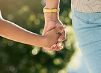 Holding hands, mother and daughter in closeup, outdoor and walking together with care, love or bonding, Mom, young kid and summer sunshine in garden, backyard or park for family, vacation and freedom