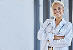 Woman, happy portrait and doctor with arms crossed in hospital for medical services, advice or mockup space in clinic. Surgeon, therapist and healthcare employee smile for pride, trust and consulting