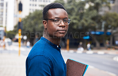 Buy stock photo Portrait, serious student and black man in city outdoor to travel to university school. Face, glasses and African learner or college person in Kenya in urban street with book in education or studying