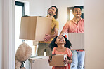 Happy, family and moving box with kid and gay parents in new home with cardboard package. Smile, child and lgbt people together with real estate and property mortgage in a house helping father