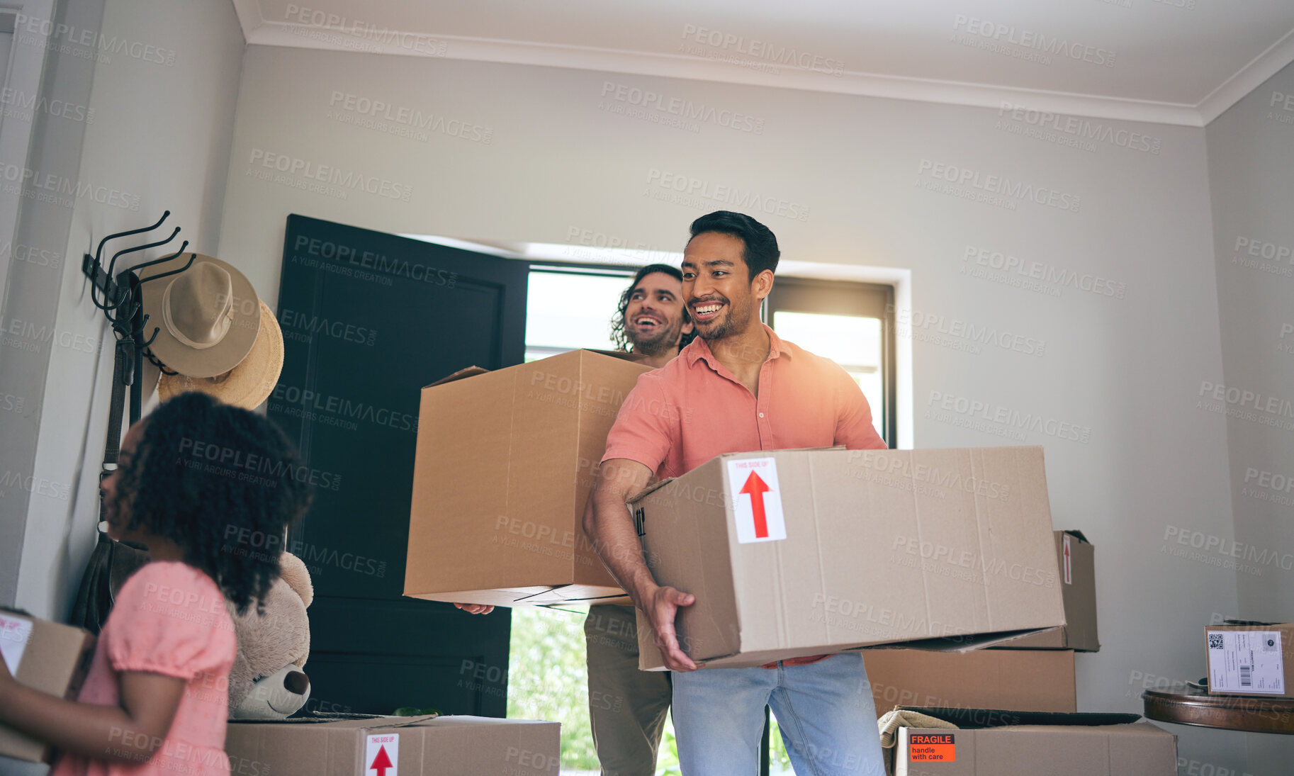 Buy stock photo Happy, new home and box moving with child and gay parents with cardboard package and family. Smile, kid and lgbt people together with real estate and property mortgage in a house helping father