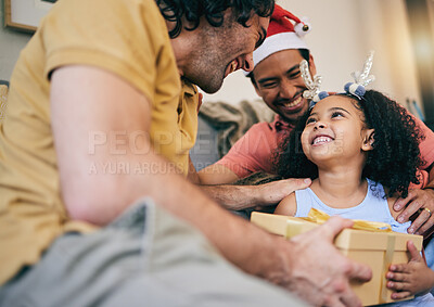 Buy stock photo Gay father, child and Christmas gift with present, house or celebration on festive holiday with smile, love or care. LGBTQ men, parents and girl kid with box, xmas fashion or culture in family home