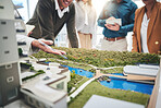 Creative people, hands and real estate with 3d model of building design, architecture or property at office. Closeup of group architect team in meeting, project planning or floor layout at workplace