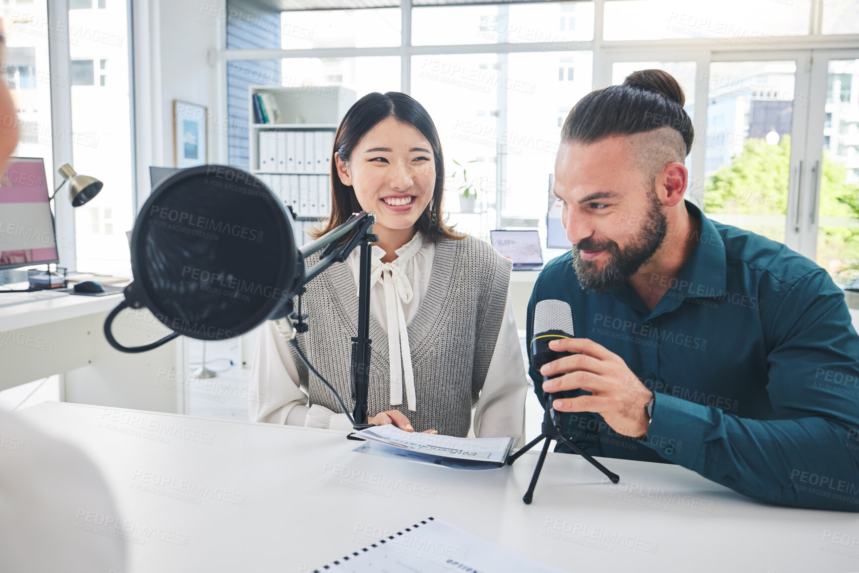 Buy stock photo Man, woman or radio presenter on microphone, news and interview with smile, finance advice and talk show. Podcast, recording and business people with speech, happy and info on live stream in studio