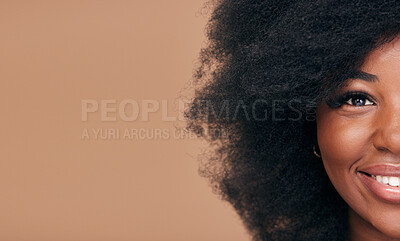Buy stock photo Portrait, hair and mockup with a model black woman in studio on a brown background for natural cosmetics. Half face, smile and haircare with a happy afro female person on space for shampoo treatment