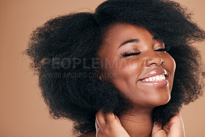 Buy stock photo Natural beauty, black woman and care for afro hair, smile and volume on a brown studio background. Aesthetic, hairstyle and African model with cosmetics after salon treatment, wellness and texture