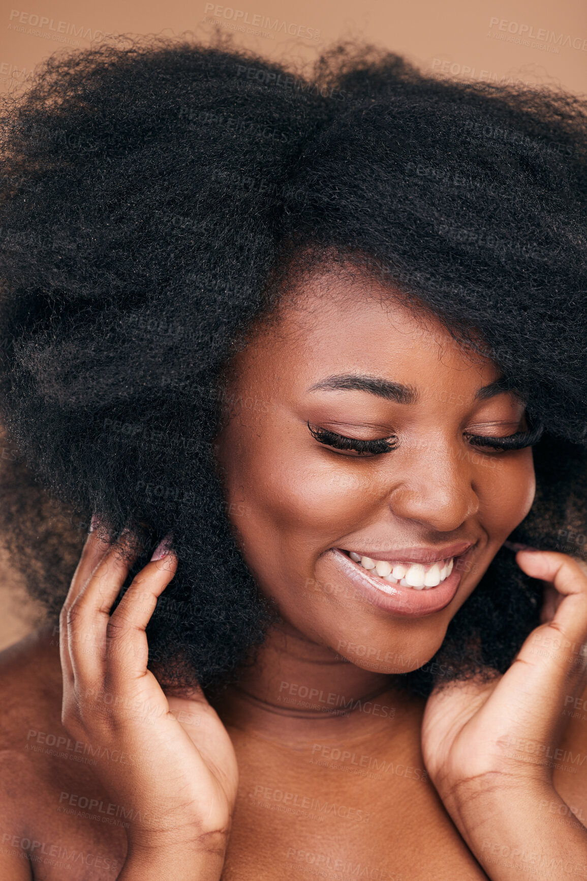 Buy stock photo Smile, black woman and natural hair care for afro, beauty and wellness on a brown studio background. Growth, hairstyle or African model with cosmetics, aesthetic or shine with salon treatment or glow
