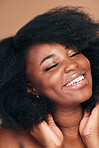 Smile, black woman and hair care for afro, beauty and self care on a brown studio background. Growth, hairstyle or African model with cosmetics after natural treatment, texture or shine with wellness