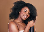 Portrait, hair and spray with a model black woman in studio on a brown background for natural cosmetics. Face, keratin and haircare with a happy young afro female person indoor for shampoo treatment