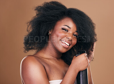 Buy stock photo Portrait, hair and spray with a model black woman in studio on a brown background for natural cosmetics. Face, keratin and haircare with a happy young afro female person indoor for shampoo treatment