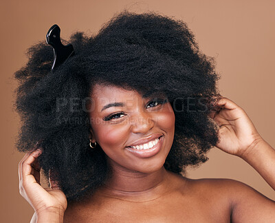 Buy stock photo Portrait, hair and comb for beauty with a black woman in studio on a brown background for natural cosmetics. Face, smile and haircare with a happy young afro female model indoor for shampoo treatment