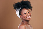 Portrait, hair care or happy black woman with afro, self love or smile on a brown studio background. Hairstyle, beauty or African model with texture, shine and volume with aesthetic, wellness or glow