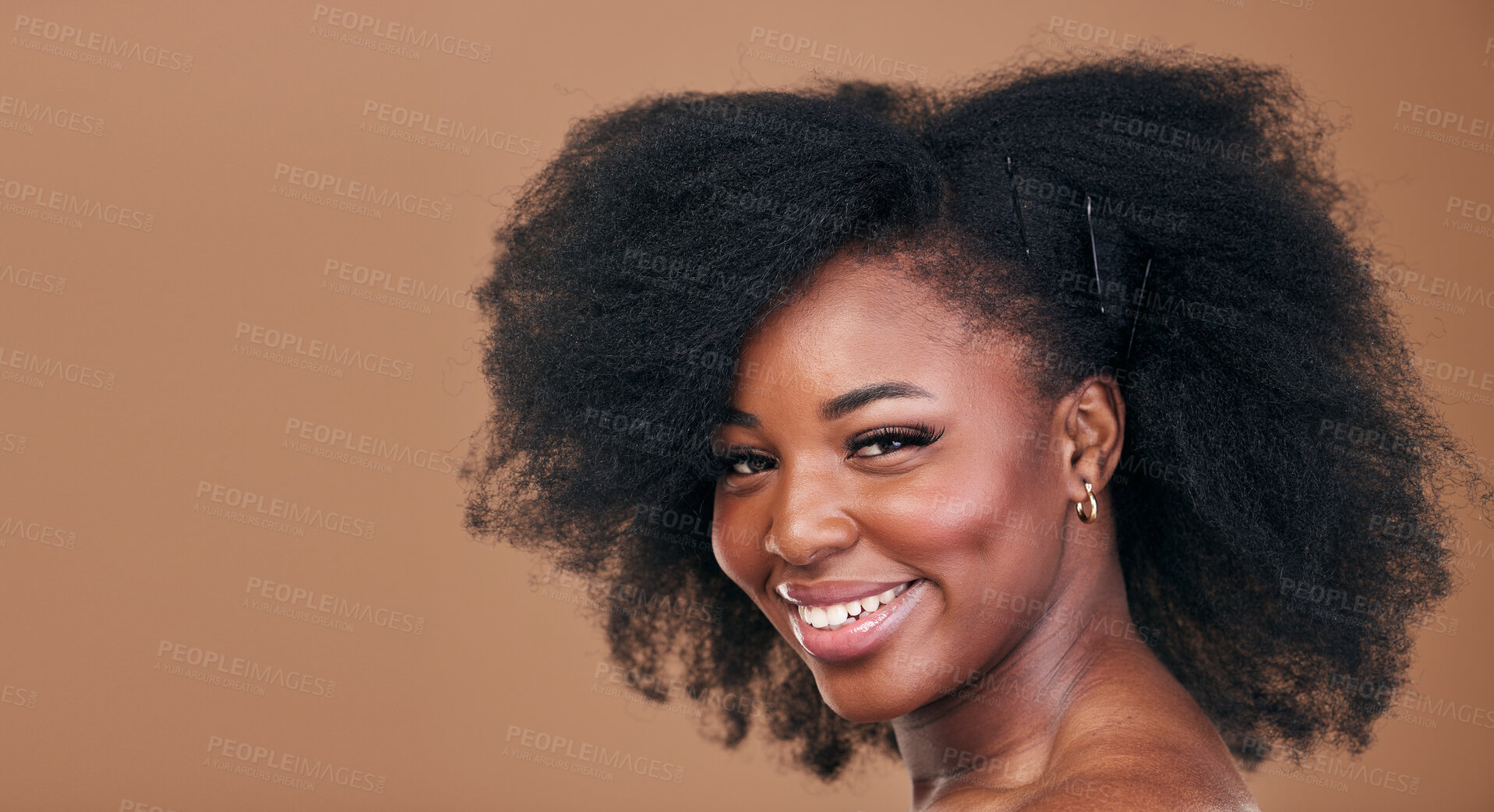 Buy stock photo Portrait, hair care and black woman with natural beauty, shine and smile on a brown studio background. Mockup space, person and model with texture, afro and volume with aesthetic, wellness and glow