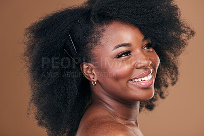 Buy stock photo Hair care, afro or face of happy black woman with self love, shine or smile on a brown studio background. Hairstyle, healthy growth or African model with glow, beauty or wellness thinking of skincare