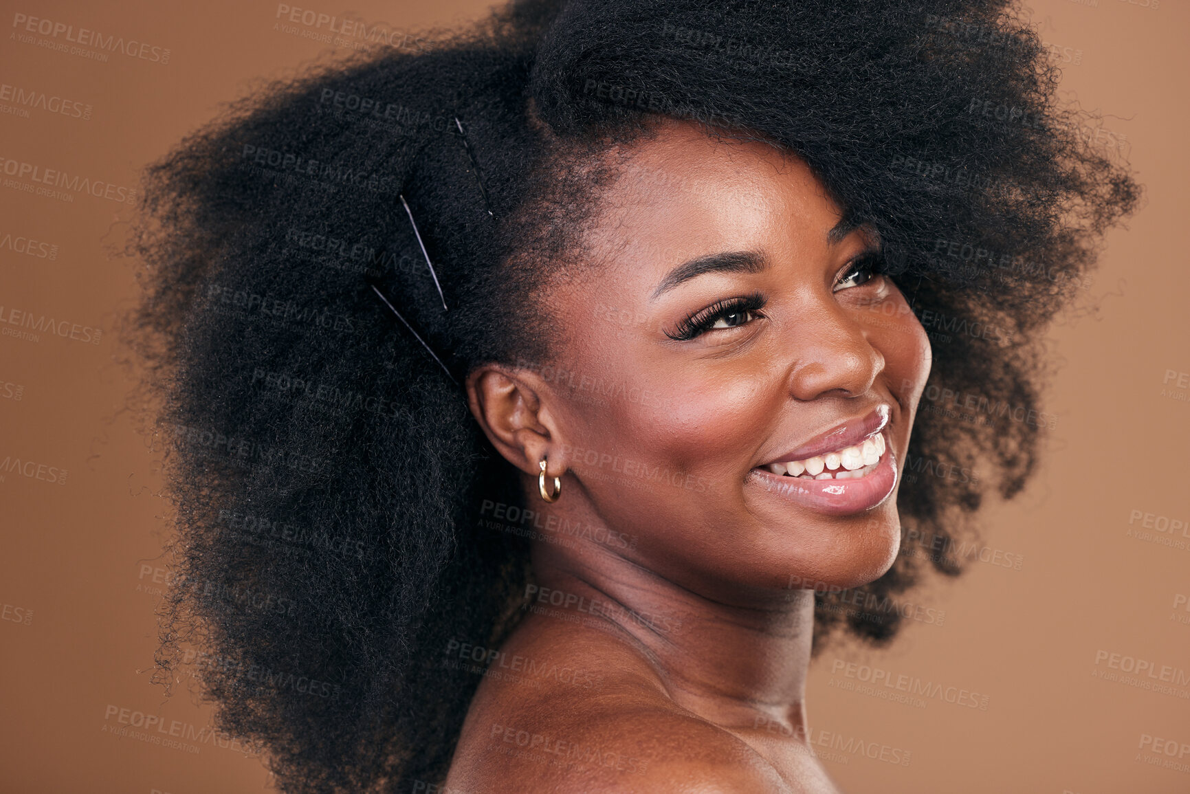 Buy stock photo Hair care, afro or face of happy black woman with self love, shine or smile on a brown studio background. Hairstyle, healthy growth or African model with glow, beauty or wellness thinking of skincare