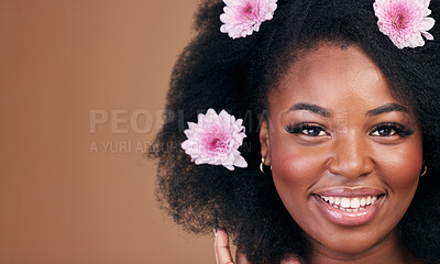 Buy stock photo Flowers, face and black woman in afro hair care, smile and beauty in studio isolated on a brown background mockup space. Portrait, floral hairstyle cosmetic and natural African model in organic salon