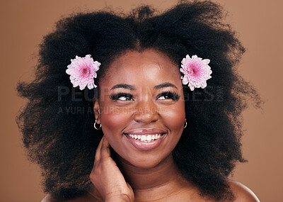 Buy stock photo Afro hair, thinking or happy black woman with flowers, beauty or smile on a brown studio background. Hairstyle, floral or natural African female model with shine or growth ideas with wellness or glow