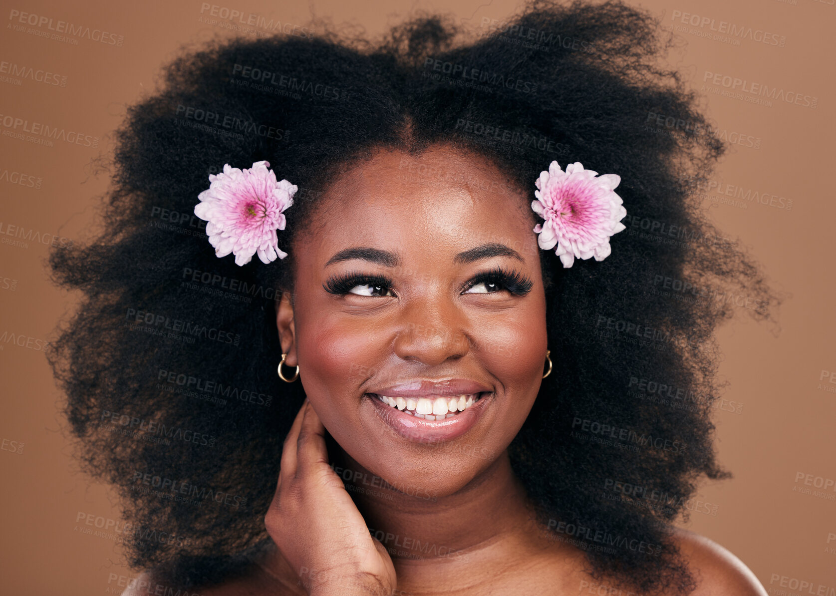Buy stock photo Afro hair, thinking or happy black woman with flowers, beauty or smile on a brown studio background. Hairstyle, floral or natural African female model with shine or growth ideas with wellness or glow