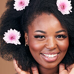 Face, flowers and black woman in afro hair care, happy and beauty in studio isolated on a brown background. Portrait, floral hairstyle cosmetics and natural African model in organic salon treatment