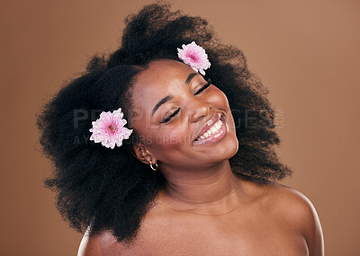 Buy stock photo Hair care, flowers and black woman, happy and beauty in studio isolated on a brown background. Smile, floral afro cosmetics or natural African model in organic salon treatment, wellness and hairstyle