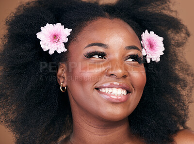Buy stock photo Hair care, flowers and black woman in afro, thinking and beauty in studio isolated on brown background. Smile, floral hairstyle cosmetic and natural African model in organic salon skincare treatment