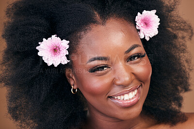 Buy stock photo Face, flowers and black woman in afro hair care, smile and beauty in studio isolated on a brown background. Portrait, floral hairstyle cosmetic and natural African model in organic salon treatment