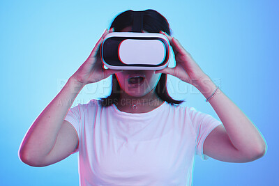Buy stock photo Woman, VR technology and surprise in studio for user experience, digital world and future multimedia game on blue background. Virtual reality glasses, metaverse and wow for innovation of UX gaming