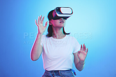 Buy stock photo Woman, VR and glasses for futuristic metaverse, 3d games and gen z education or digital e learning. Young person or student in virtual reality, high tech with vision, neon and blue,studio background
