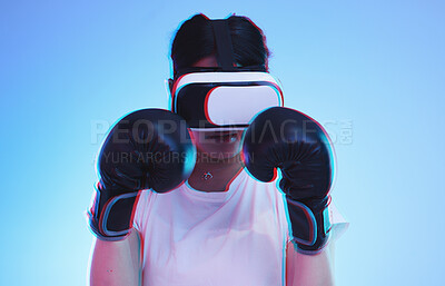 Buy stock photo AI, metaverse and a boxer woman gaming on a blue background in studio for fitness or exercise. Virtual reality, sports and training with a young female player boxing an online fantasy game for health
