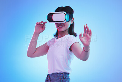Buy stock photo Metaverse gaming, headset and woman on blue background for virtual reality creativity. Smile, touching and a girl with digital glasses for a cyber game, experience or future technology on a backdrop