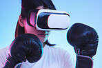 Sports, metaverse and a gamer woman boxing on a blue background in studio for fitness or exercise. Virtual reality, ai and training with a young female boxer playing an online fantasy game for health