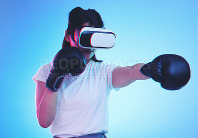 Buy stock photo AI, metaverse and a gamer woman boxing on a blue background in studio for fitness or exercise. Virtual reality, sports and training with a young female boxer playing an online fantasy game for health