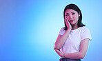 Mockup, neon and portrait of Asian woman in studio for information, promotion and deal on blue background. Creative lighting, marketing and isolated person with space for news, announcement and sale