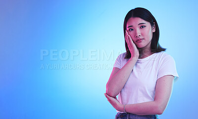 Buy stock photo Mockup, neon and portrait of Asian woman in studio for information, promotion and deal on blue background. Creative lighting, marketing and isolated person with space for news, announcement and sale