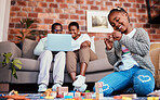 Playing, smile and a child with building blocks and parents on the sofa with a laptop in a house. Happy, black family and a girl kid with toys on the lounge floor for education, learning and a game