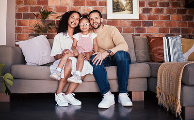 Buy stock photo Portrait of happy family in living room, parents and child on sofa with love, bonding and relax in home. Mom, dad and girl kid on couch in apartment with smile, man and woman with daughter together.
