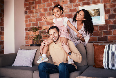 Buy stock photo Family, happy and portrait while playing on a home sofa for fun, bonding and time together. A man, woman and girl kid in a lounge with love, care and happiness for airplane game in Puerto Rico house