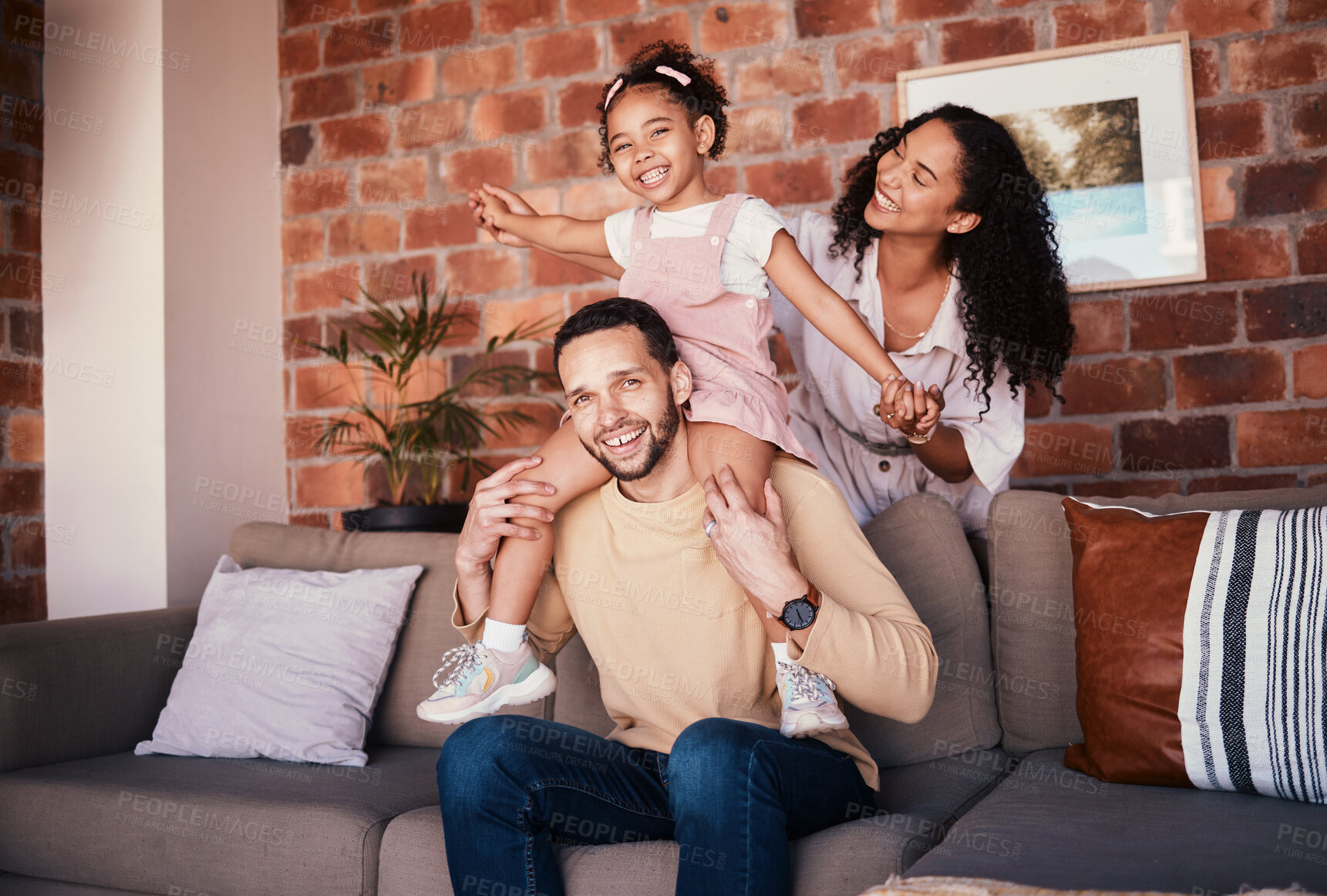 Buy stock photo Family, happy and portrait while playing on a home sofa for fun, bonding and time together. A man, woman and girl kid in a lounge with love, care and happiness for airplane game in Puerto Rico house
