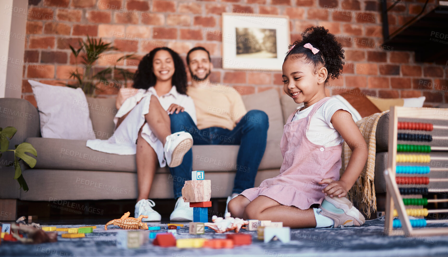 Buy stock photo Happy, playing and a child with building blocks and parents for relax, education and learning in a house. Smile, playful and a girl kid with toys and a mother and father in a living room as family