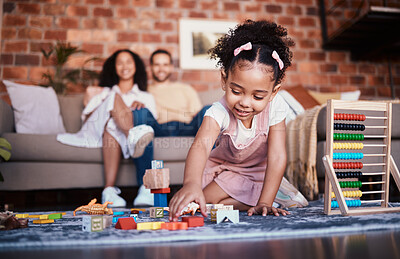Buy stock photo Child, toys and playing in home with development and building block in living room. Family, fun and youth learning with a young girl and parents in a house together with care and bonding education